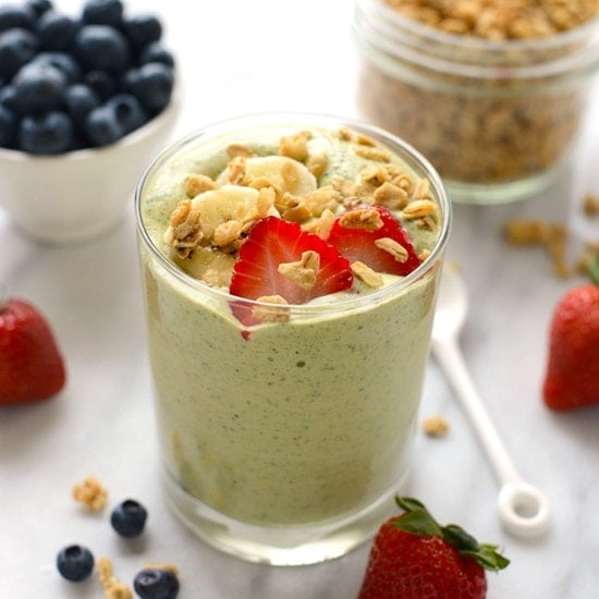 A spinach smoothie with berries and granola.