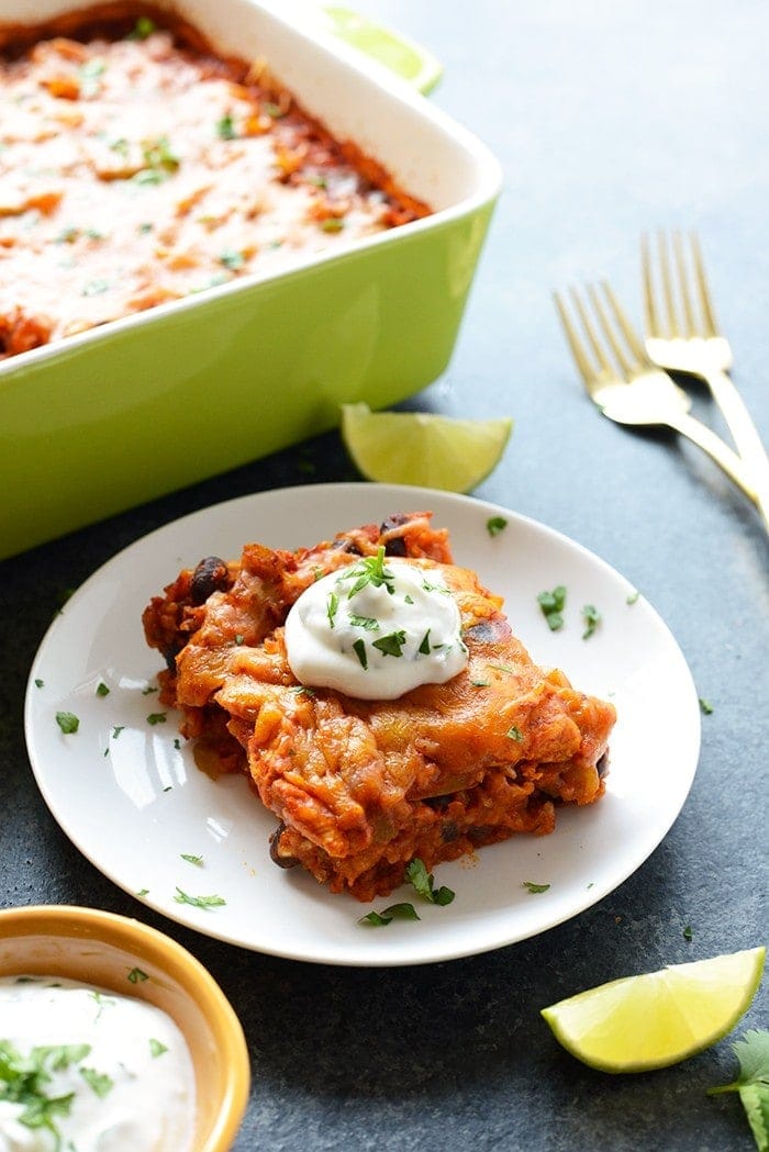 In just 60 minutes you can make this healthy chicken enchilada casserole that's packed with lean chicken, beans, tons of veggies, and brown rice. Throw everything into a casserole dish uncooked (that's right...UNCOOKED) and you've got yourself dinner for the entire family.