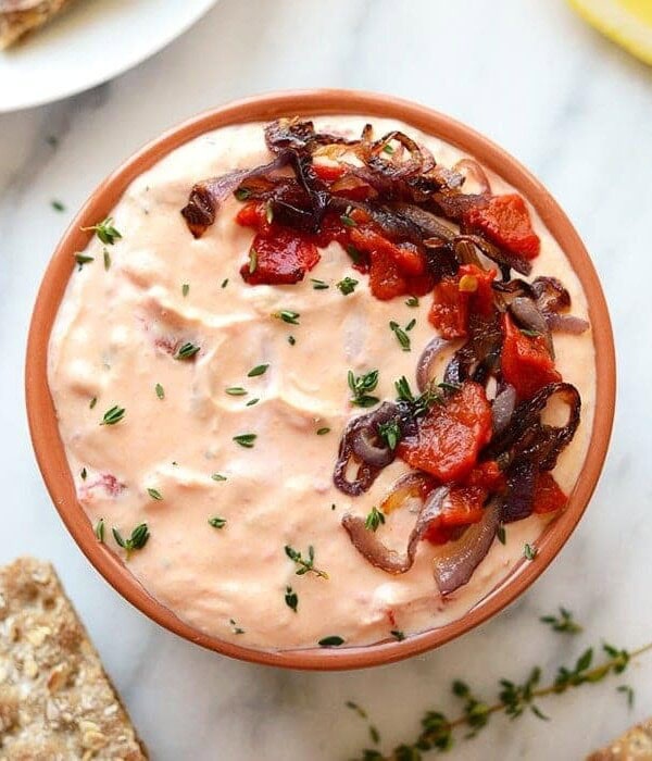 a skinny roasted red pepper and goat cheese dip with bread.
