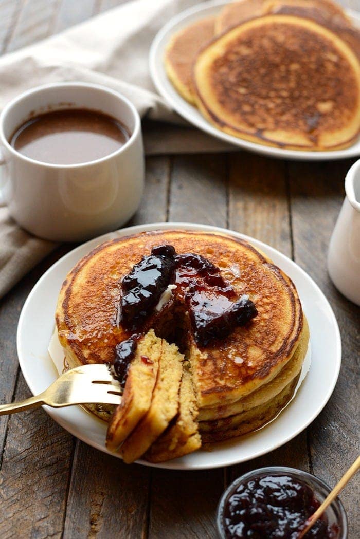 Taking a bite of cornmeal whole wheat pancakes