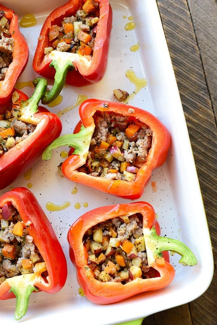 Get your meal prep on with these delicious breakfast stuffed peppers! They're made with a breakfast sausage/sweet potato hash mixture on the bottom and a baked egg on top.