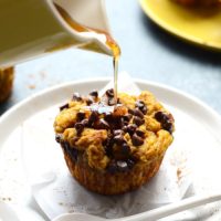 Pumpkin French toast cups being drizzled with honey.