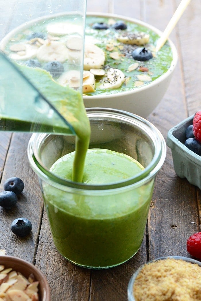 healthy green smoothie being poured into a glass