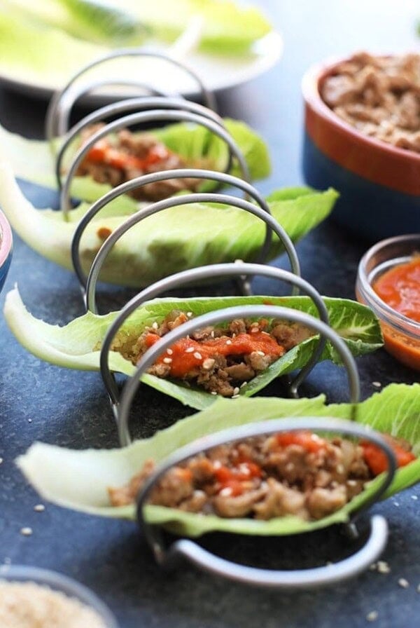 Chicken lettuce wraps with meat and sauce on a plate.