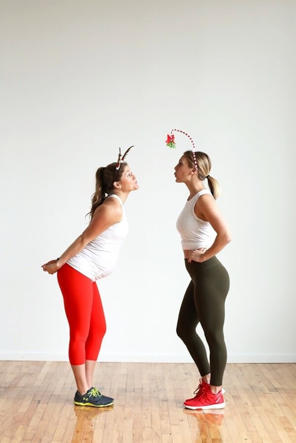 Two women in Christmas attire participating in a bootcamp workout.
