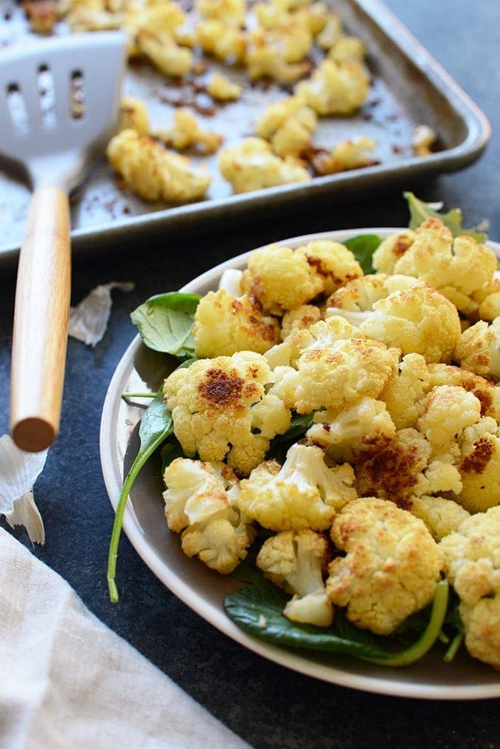 This Super Simple Garlic Roasted Cauliflower is the perfect flavor-packed, healthy side dish for any meal. It even makes for a great snack! 