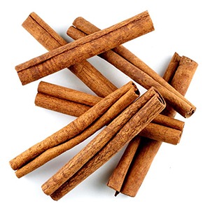 A hot toddy recipe featuring cinnamon sticks on a white background.