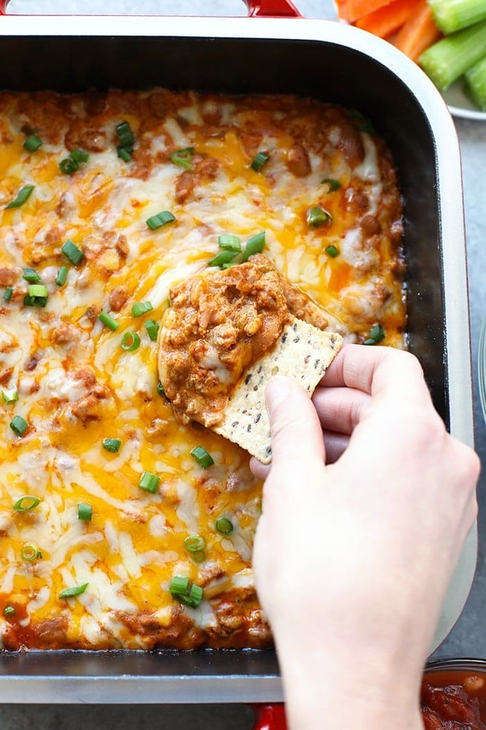 Make this winning chili cheese dip for the big game and your guests will gobble it up. It really is the best chili cheese dip recipe! chip scooping dip