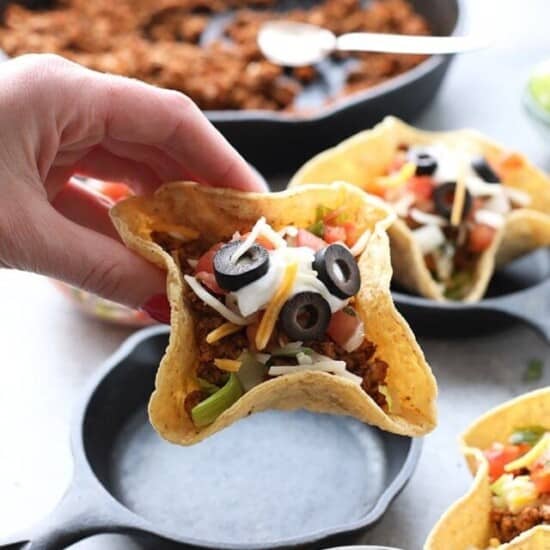 a hand holding a Mini Taco Cup
