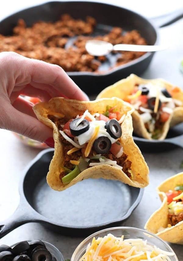 a hand holding a Mini Taco Cup