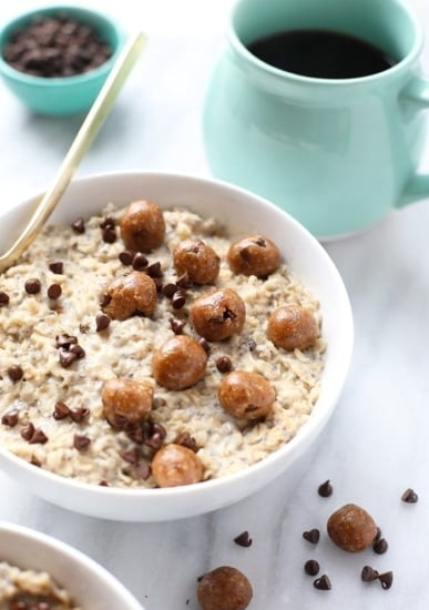 A bowl of Chocolate Chip Cookie Dough Oatmeal with a cup of coffee.