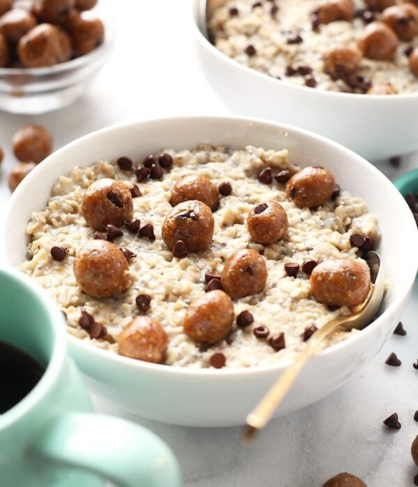 A bowl of Chocolate Chip Cookie Dough Oatmeal accompanied by a cup of coffee.