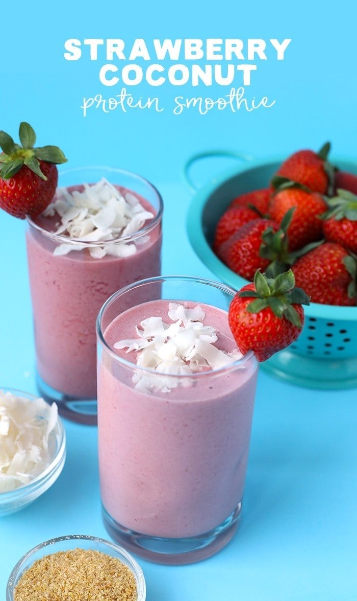 two strawberry coconut protein smoothies next to ingredients in bowls 