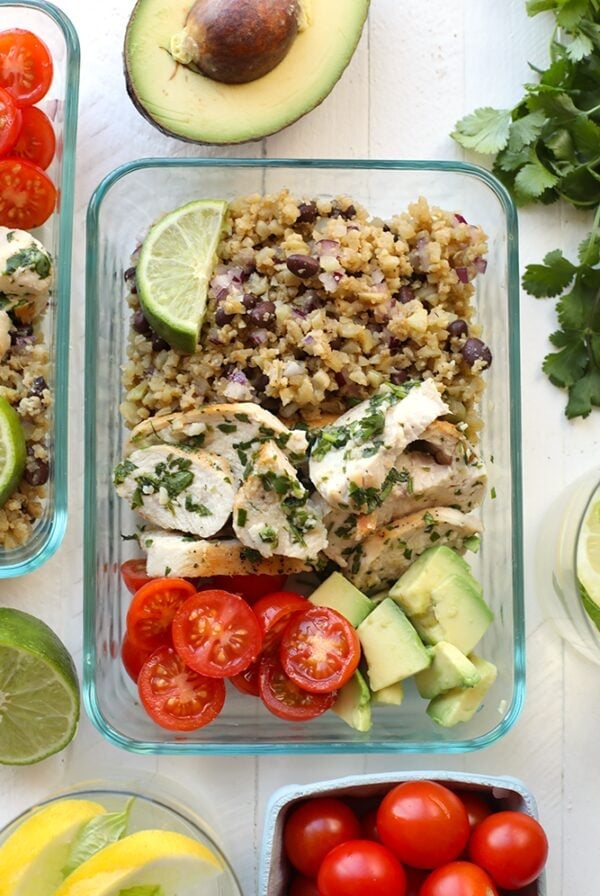 Quinoa bowls featuring Mexican flavors, with Cilantro Lime Chicken and fresh ingredients like avocado, tomatoes and limes.