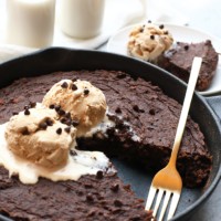 a skillet dessert with chocolate chip cookie and ice cream, reminiscent of sweet potato brownies.