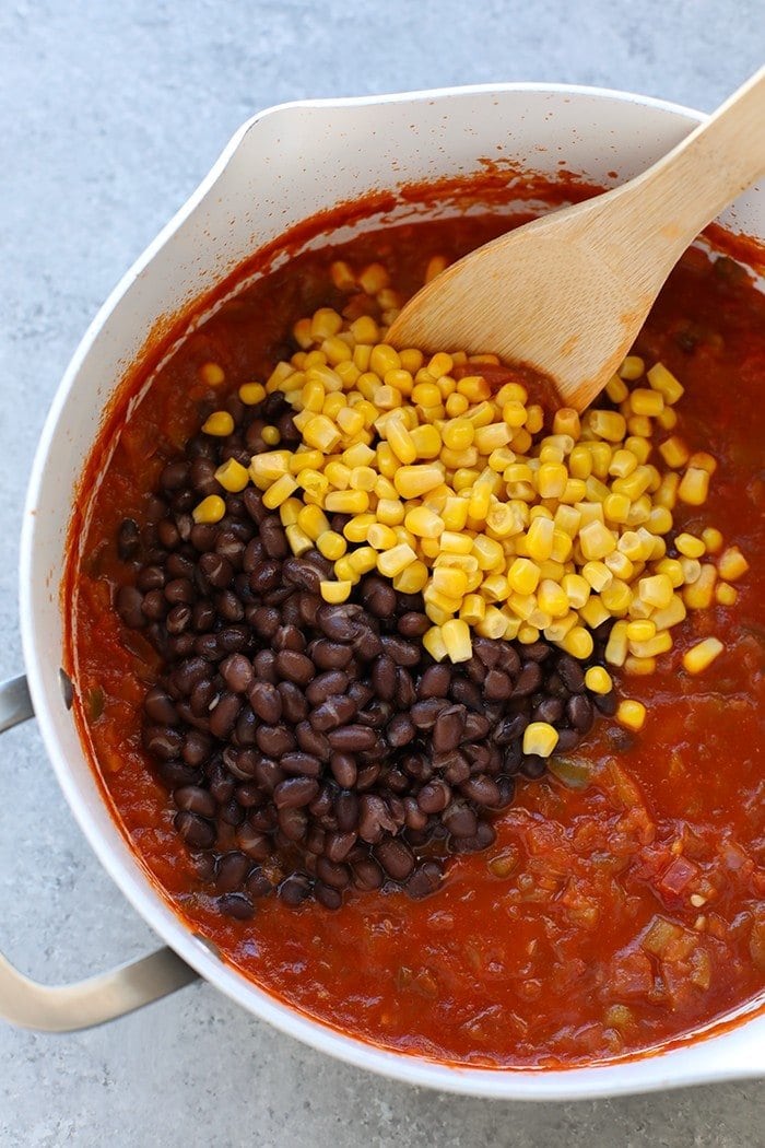 corn, black beans and salsa in pan for chilaquiles