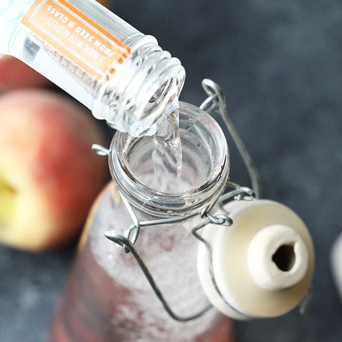 peach infused vodka in a glass jar