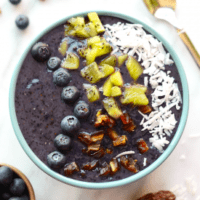 A bowl of blueberry chia pudding with blueberries and granola.