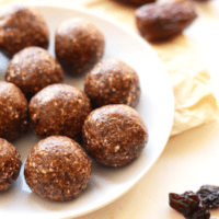 Chocolate energy balls on a white plate.