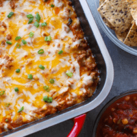 Cheesy mexican dip in a baking dish.