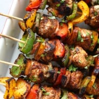 Grilled chicken fajita kebabs on skewers with peppers and onions.