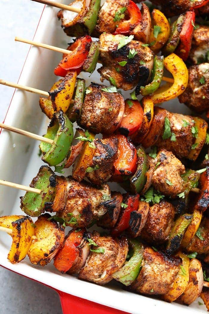 chicken fajita kabobs in casserole dish.