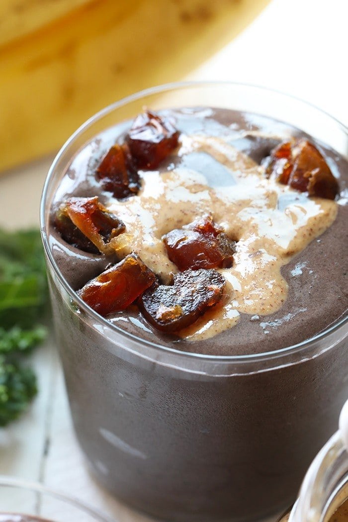 Dark Chocolate Date Protein Smoothie in glass with dates on top