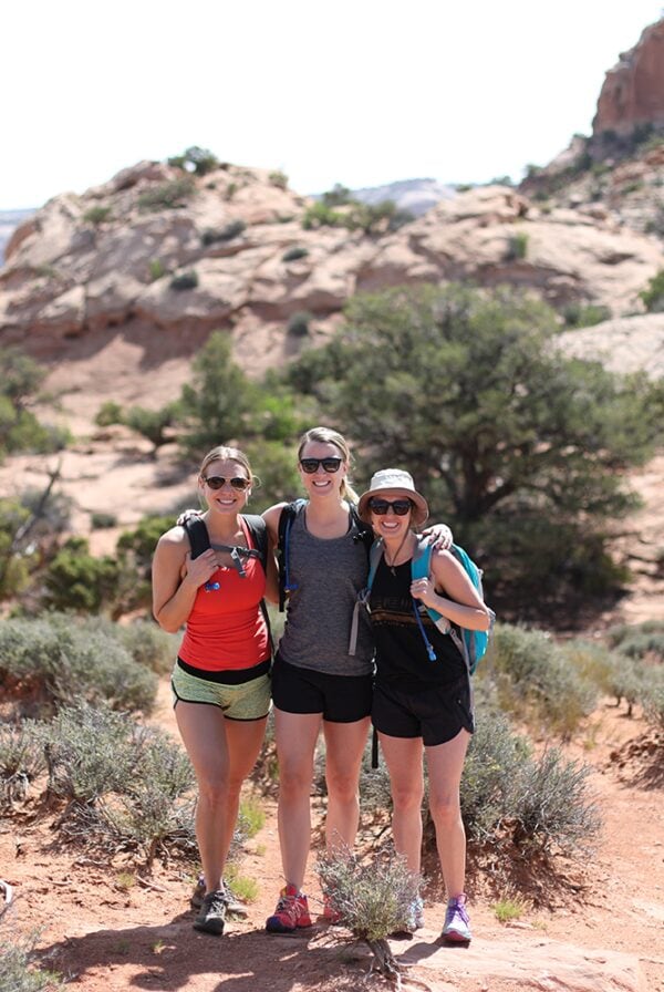 Three Fit Foodie Travels women standing on a trail in Moab desert.