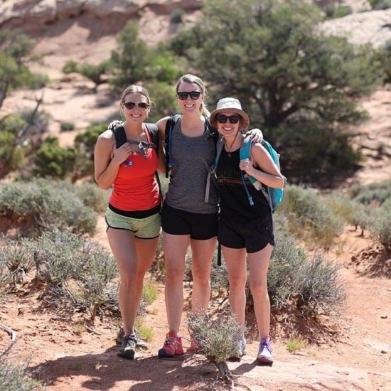 Three Fit Foodie Travels women standing on a trail in Moab.