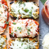 Roasted sweet potato skewers with pesto and basil arranged on a cutting board.