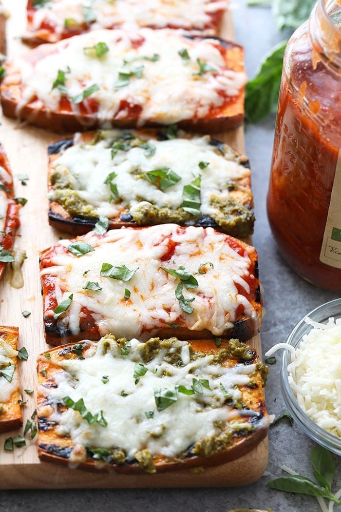 Wow the fam with these amazing grilled sweet potato pizzas! All you need is sweet potatoes, your favorite marinara sauce or pesto, mozzarella, and your favorite pizza toppings for this healthy 30 minute meal.