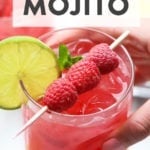 A refreshing drink made with ginger and raspberries, known as a raspberry ginger mojito.