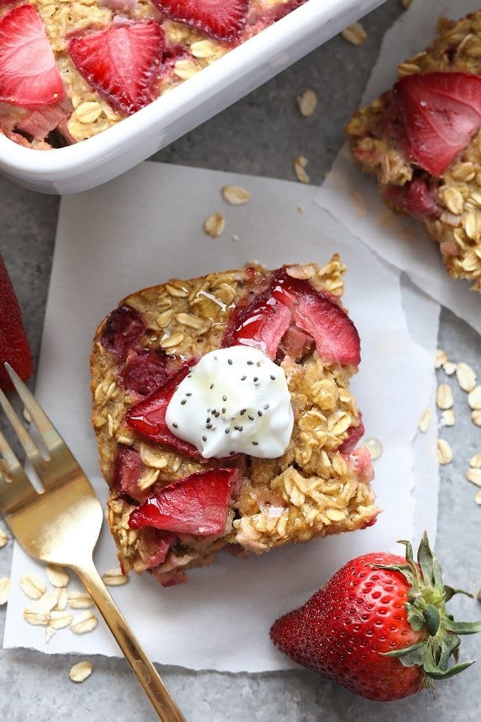 Make breakfast a breeze with this Strawberry Rhubarb Baked Oatmeal. This strawberry rhubarb recipe is the perfect healthy breakfast that's packed with fiber, protein, and will satisfy your sweet tooth while keeping you full until lunchtime! Slice of strawberry rhubarb oatmeal bake ready to be served.