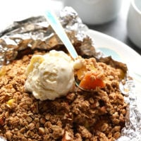 Peach season is here and this foil-pack peach crumble recipe on the grill is easy, delicious, and healthy! It's made with juicy peaches tossed in maple syrup and a yummy crumble topping, making it a gluten free fruit crumble and a healthy dessert recipe for the summertime!