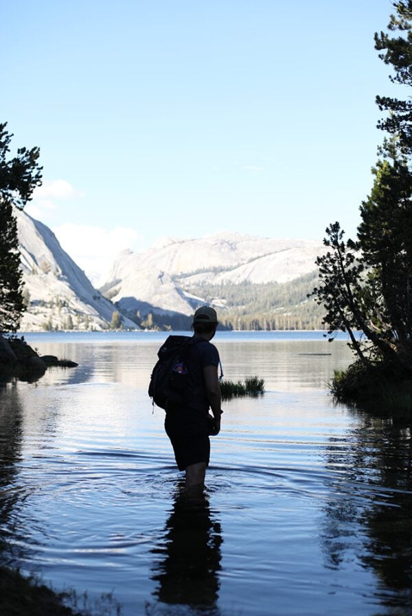 A backpacker exploring a lake in Yosemite National Park during the 48 Hour trip.