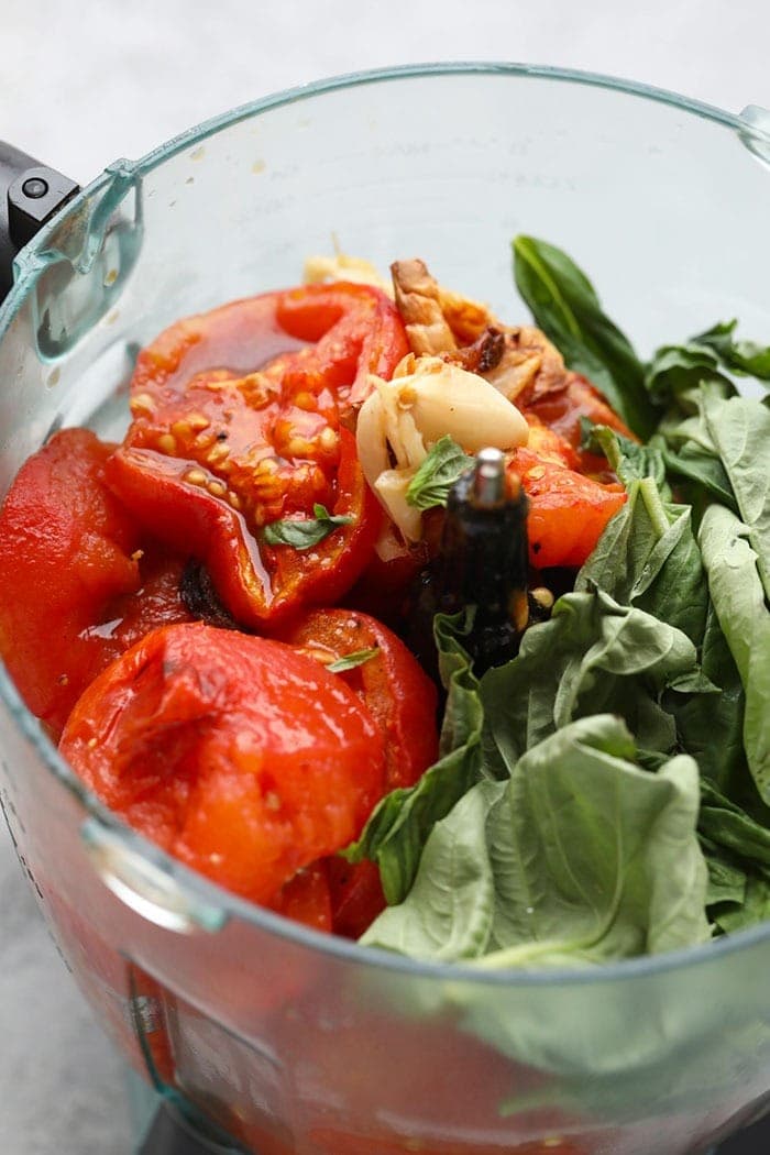 tomatoes, garlic, and basil in food processor.