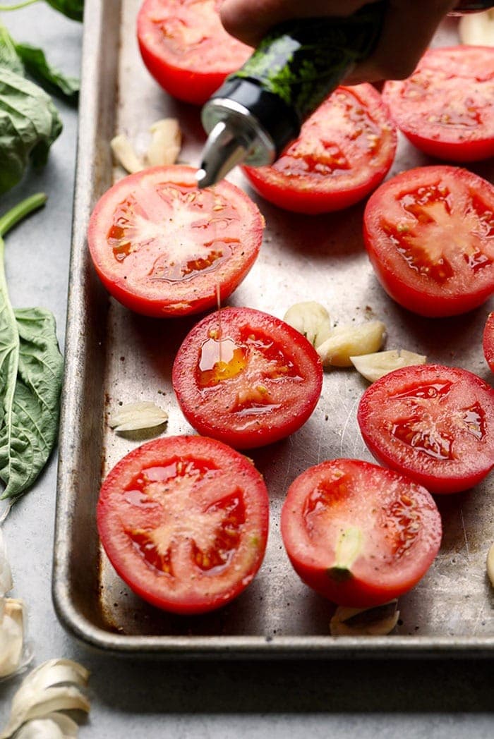 juicy tomatoes and garlic on pan.