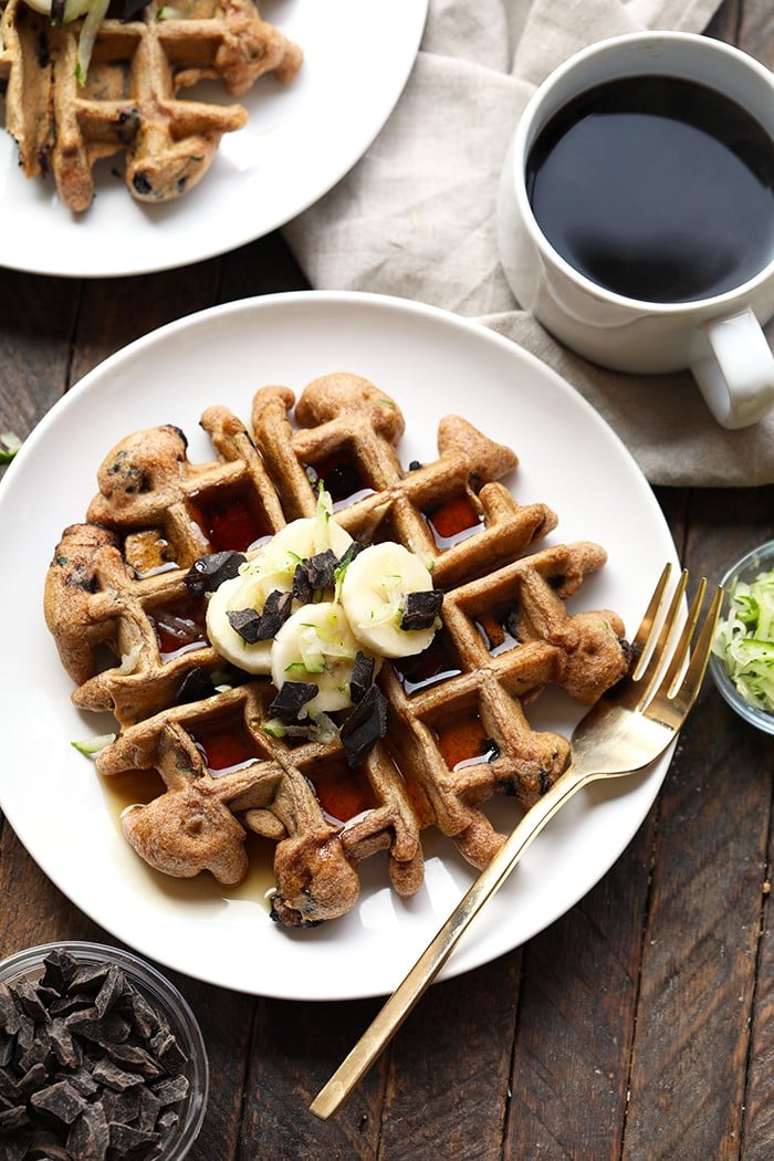 zucchini waffles with bananas on plate.