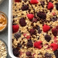 A dish of oatmeal with berries and peanut butter.