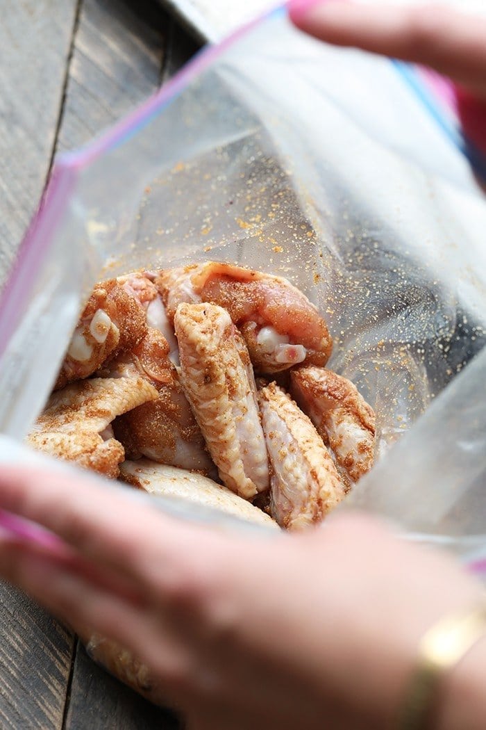 Unbaked chicken wings in ziploc bag with spices