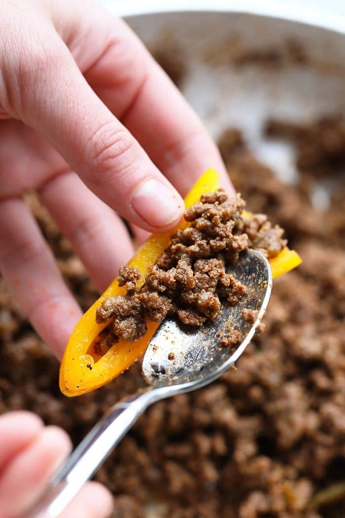 filling mini bell peppers with beef.