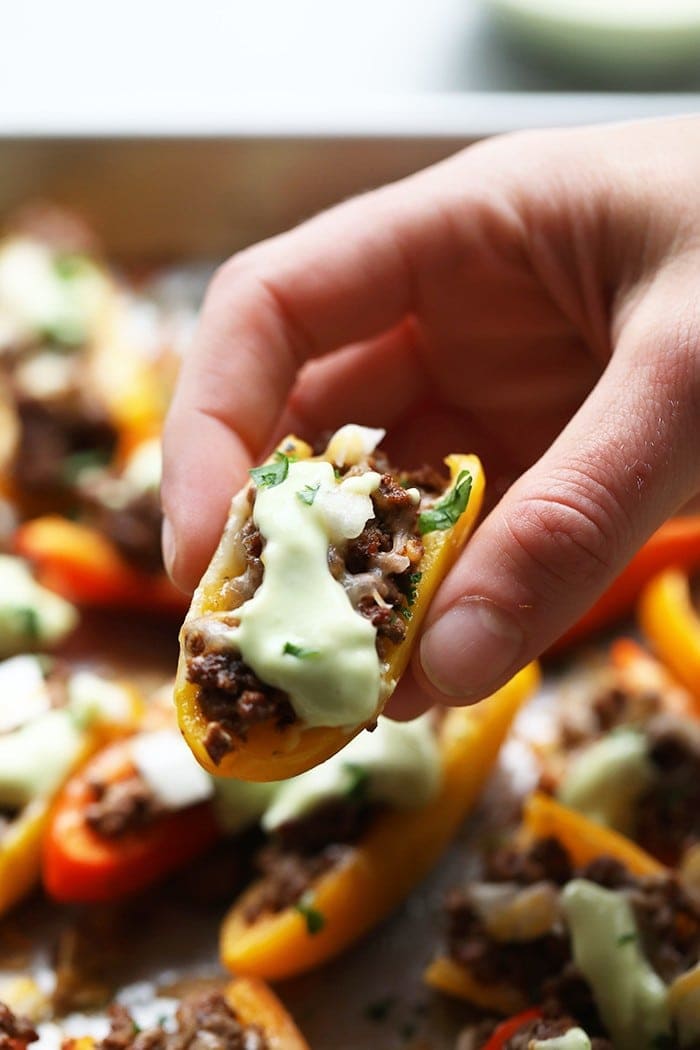 hand holding fajita nachos.