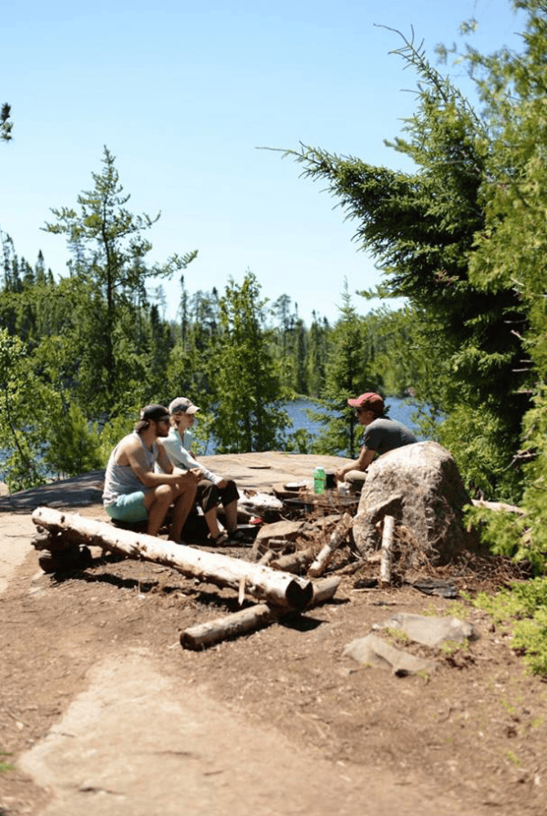 a group of people sitting around a campfire in Minnesota.