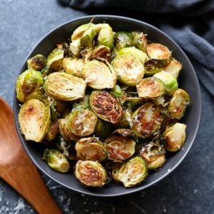 Roasted Brussels sprouts topped with parmesan in a bowl.