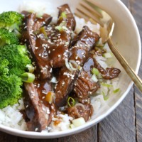 Sous vide flank steak and broccoli in a white bowl.