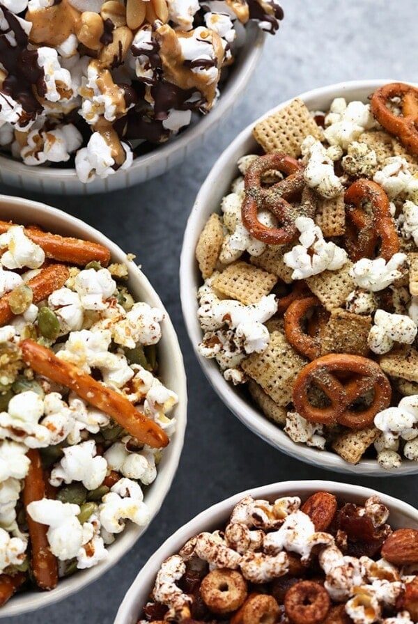 four bowls of easy popcorn snack mixes.