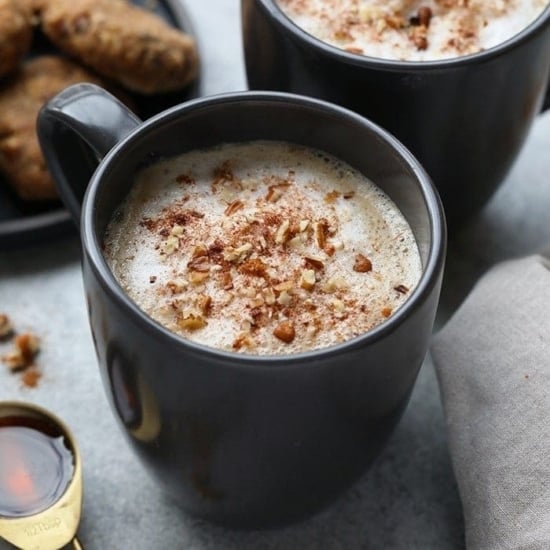 Two DIY maple pecan lattes with cookies on a table.