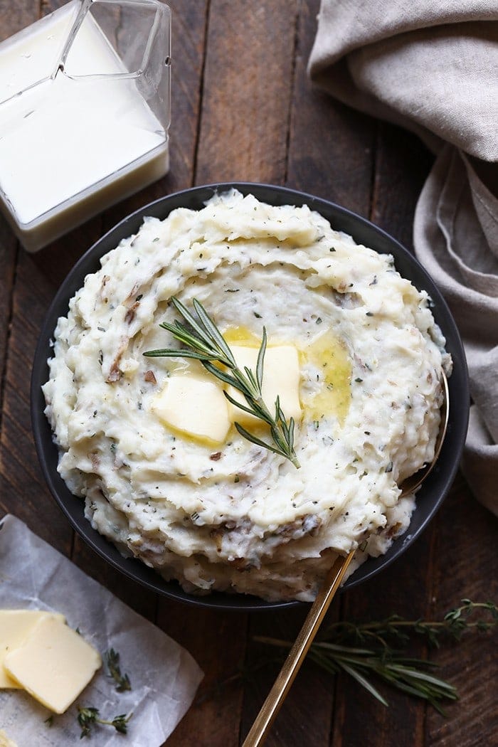 Add these lightened-up herby mashed potatoes to your Thanksgiving dinner. They're made with russet potatoes, Greek yogurt, a little bit of butter, and tons of fresh herbs for a flavorful, healthy side dish.