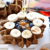 Banana Bread Waffles drizzled with syrup and topped with blueberries.