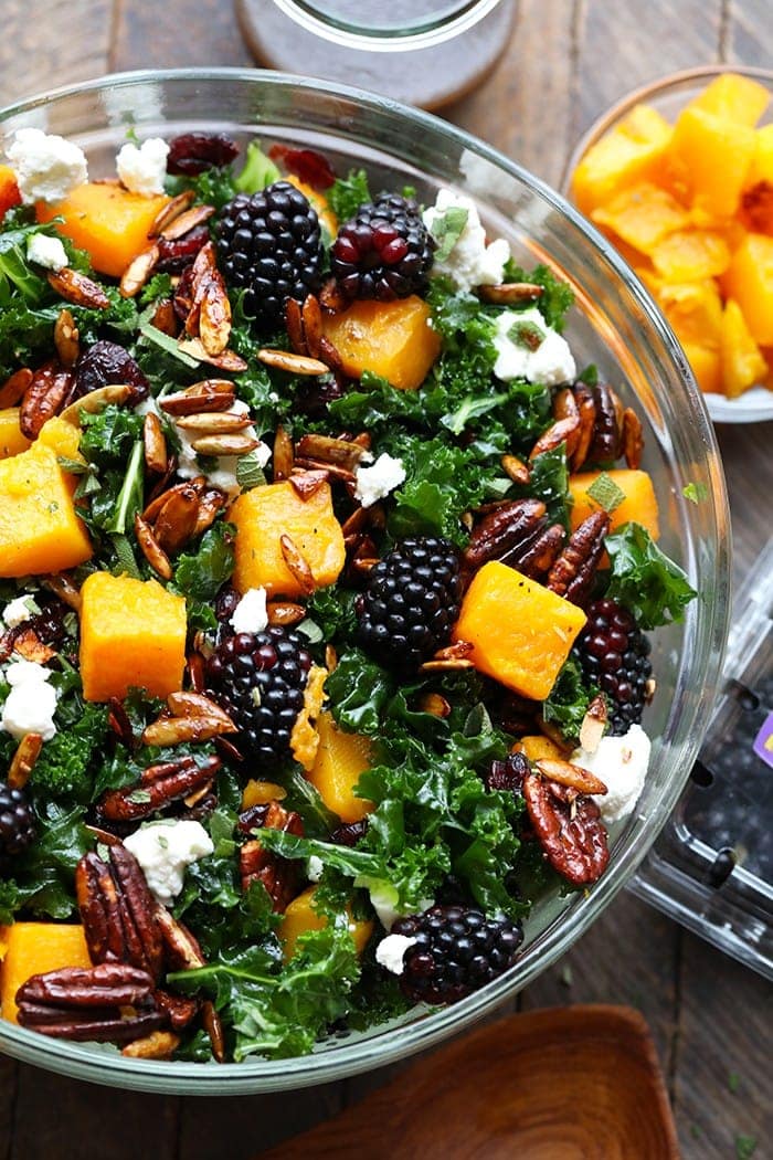 This Harvest Blackberry and Butternut Squash Massaged Kale Salad is an excellent healthy lunch or dinner and even doubles as a holiday salad to share. It's made with roasted butternut squash, candied nuts, Driscoll's blackberries, and massaged kale with a homemade dressing!